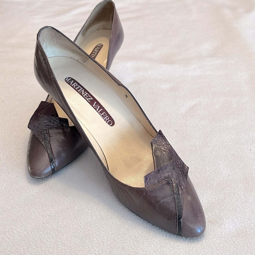 Brown classic pumps with a flair is style that include textured leather flap